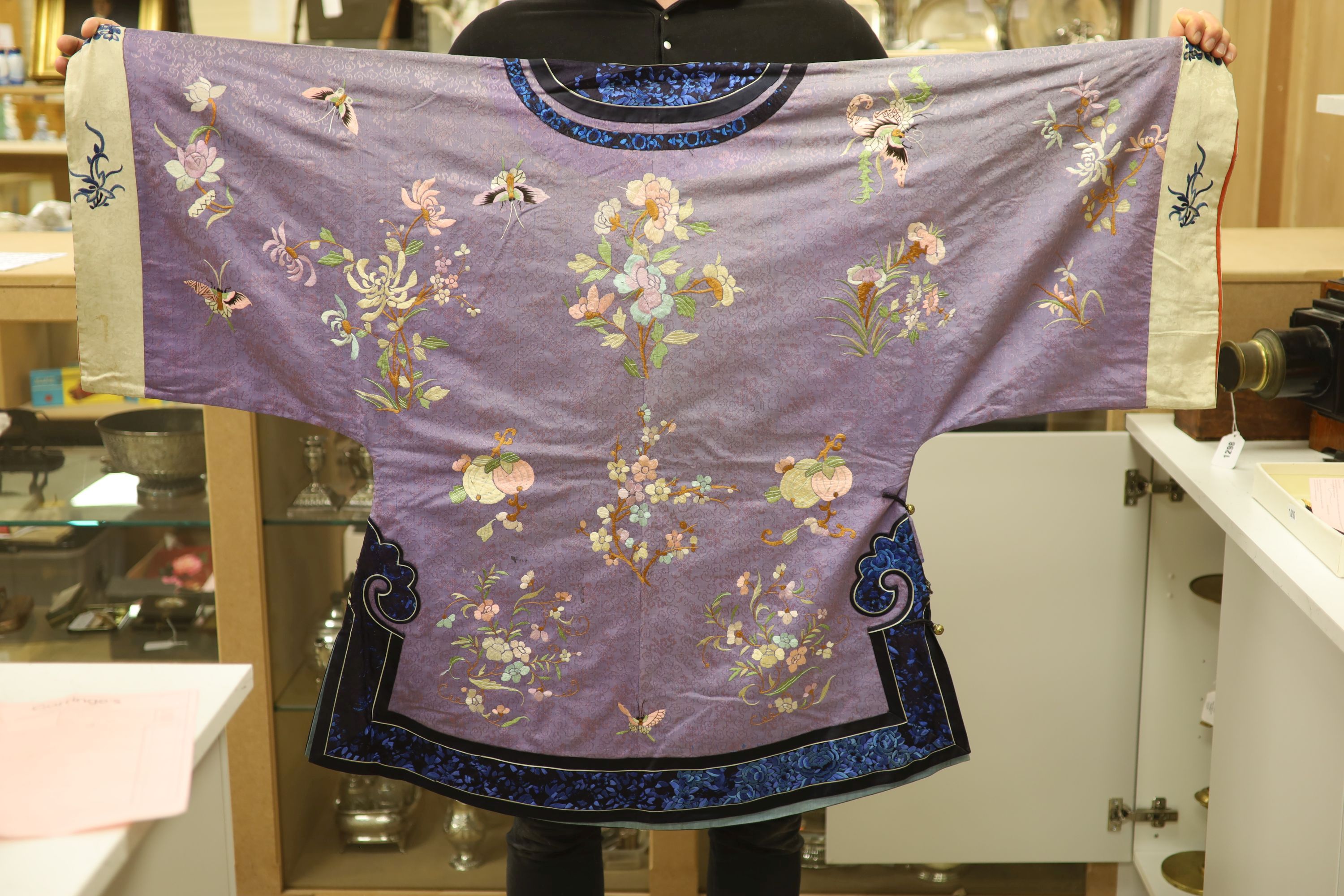 A Chinese lilac silk embroidered robe, early 20th century with multi-coloured embroidery and wide embroidered sleeve bands,